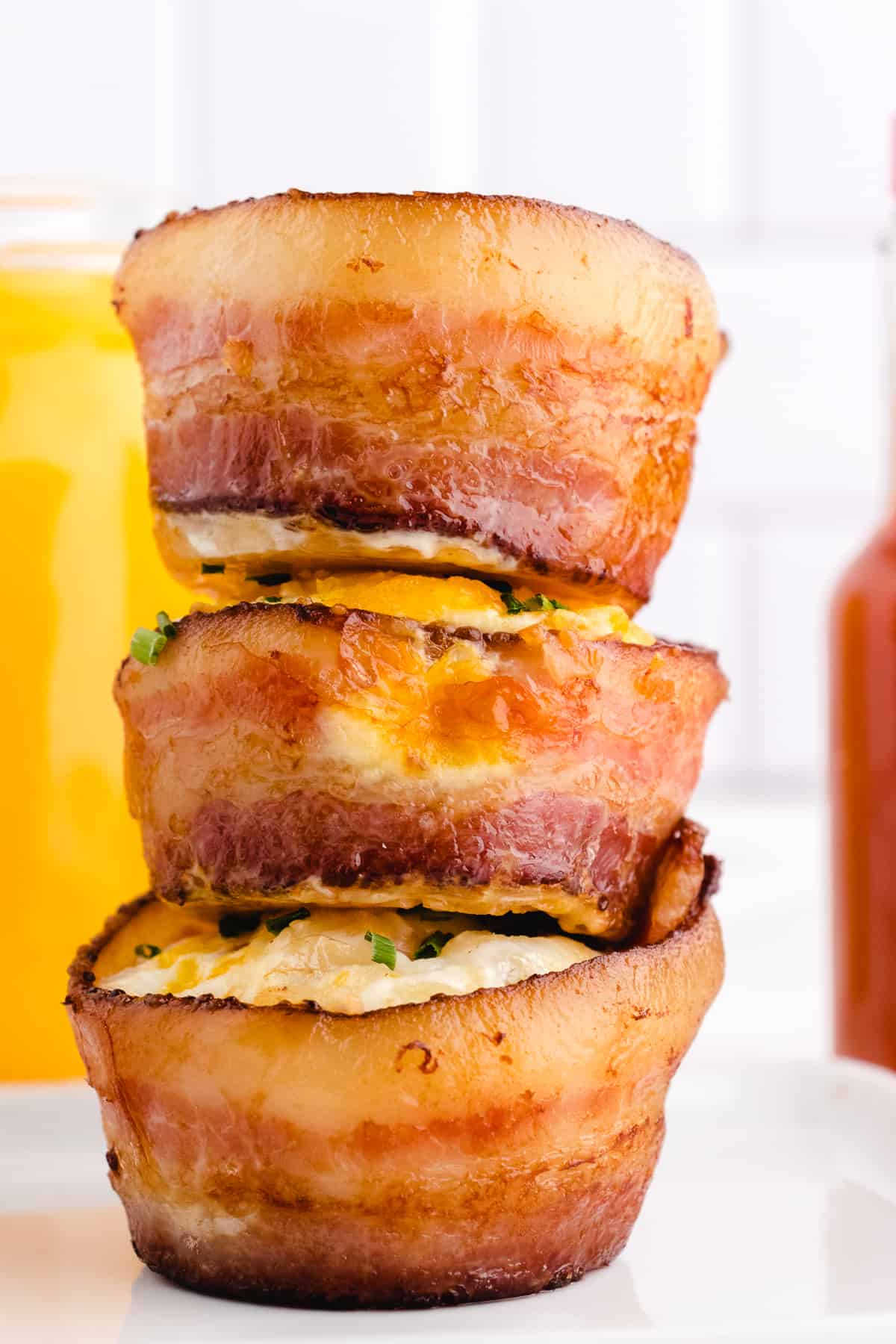 baking eggs in a muffin cup with the cooked eggs stacked on top of each other