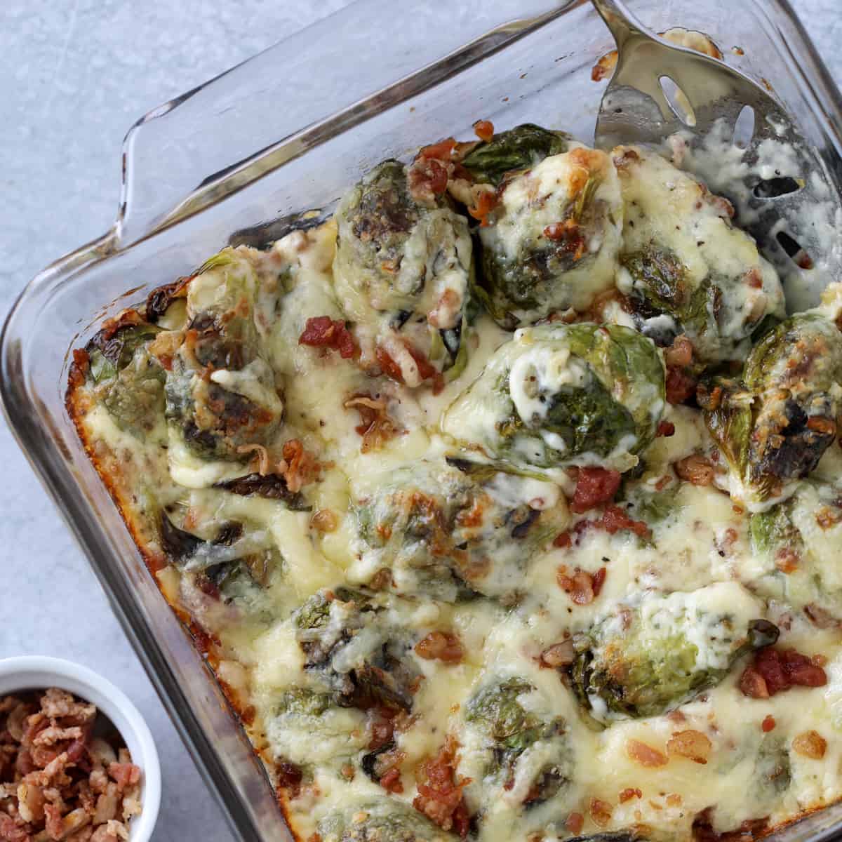 brussel sprouts keto recipe with a scoop of the cheesy brussel sprouts on a spoon