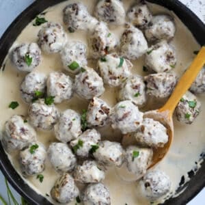 gluten free swedish meatballs with whipping cream in a skilet