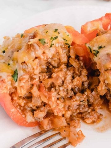 cutting into a stuffed bell pepper after it's finished baking