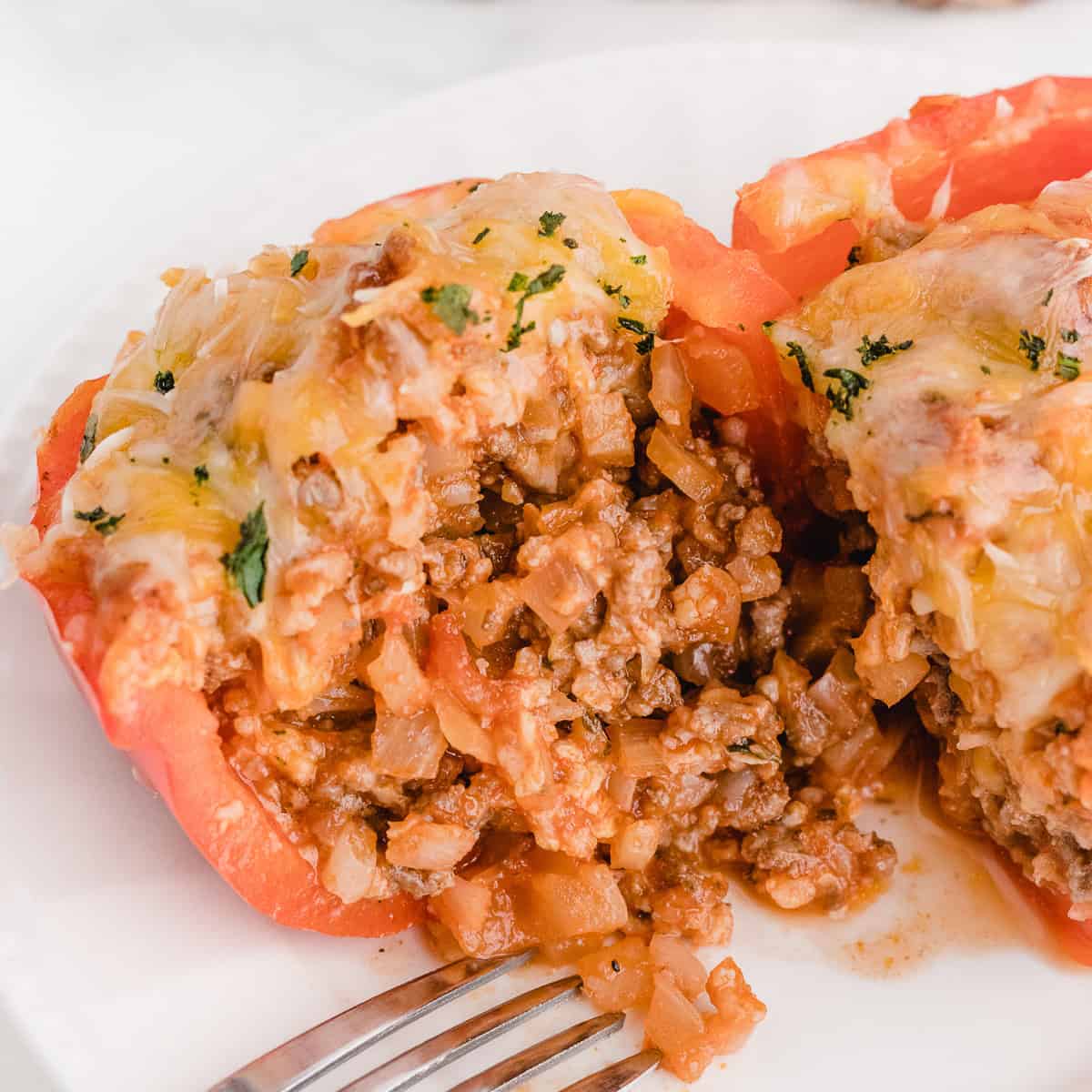 cutting into a stuffed bell pepper after it's finished baking