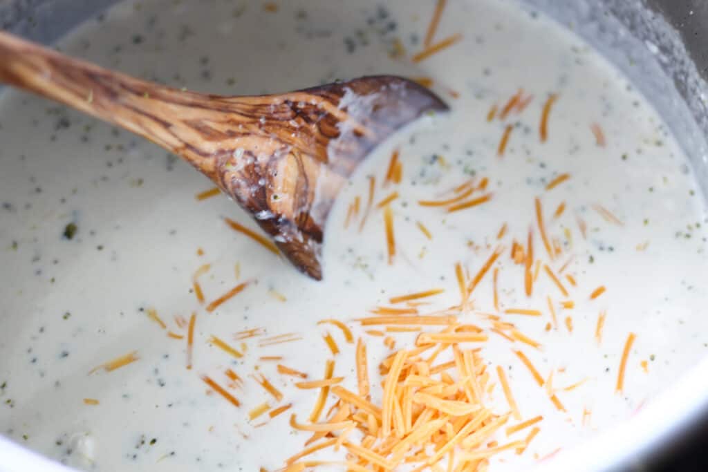 stirring the cheese into the soup after pressure cooking
