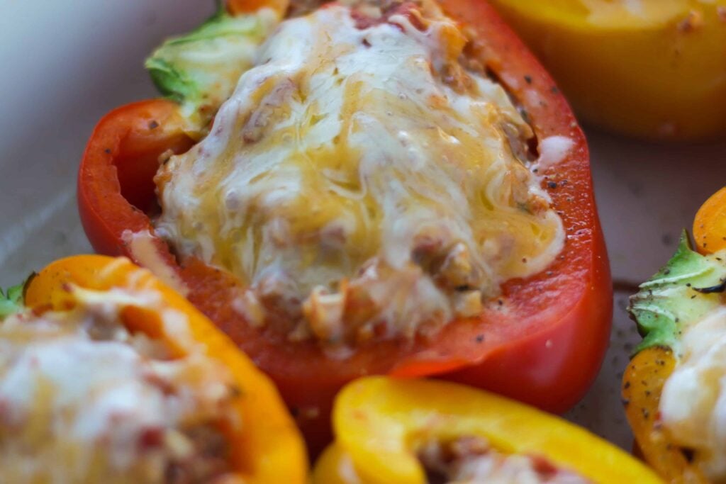 close up of cheesy stuffed bell peppers after baking