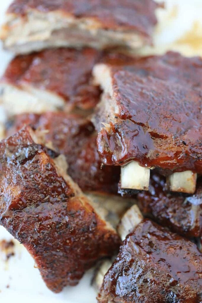 oven baked baby back ribs with sauce on a plate after cooking