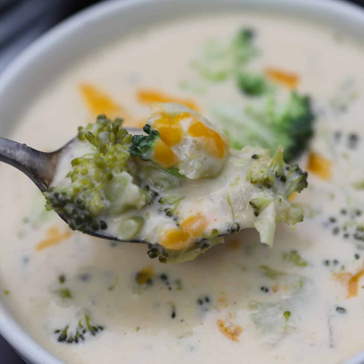 instant pot broccoli cheese soup bite on a spoon