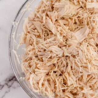 chicken in a bowl after shredding chicken with a kitchenaid mixer