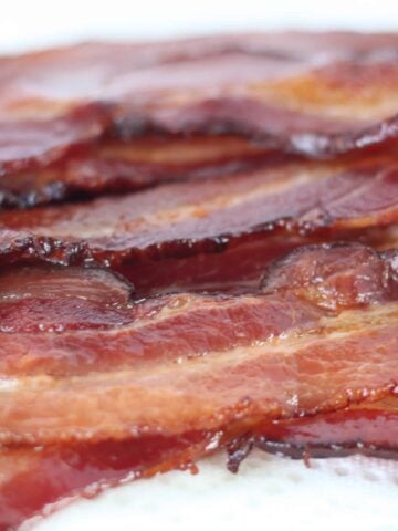 baked bacon on a white background after cooking