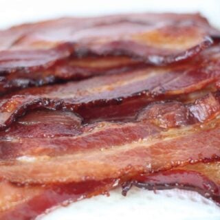 baked bacon on a white background after cooking