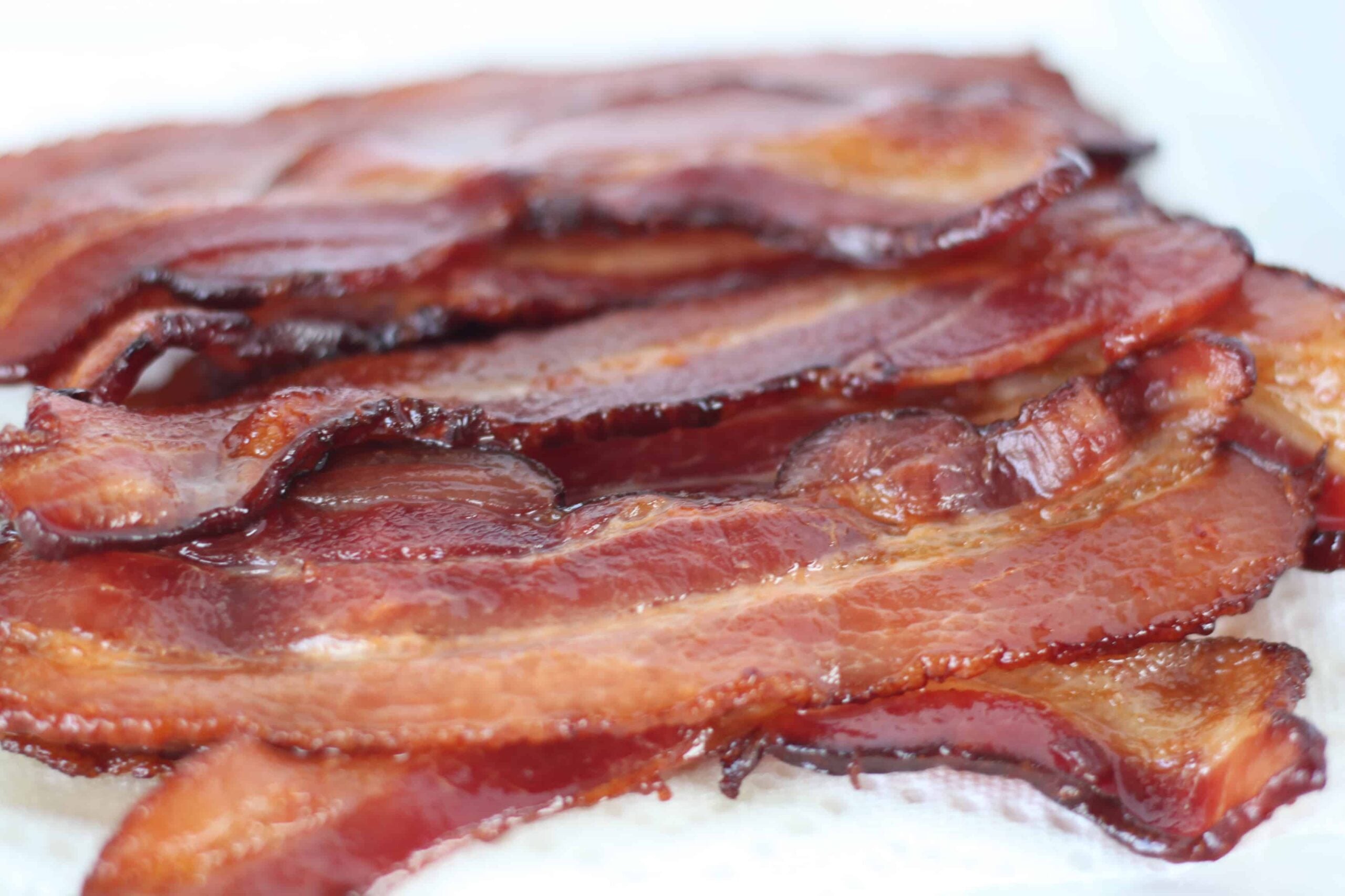baked bacon on a white background after cooking