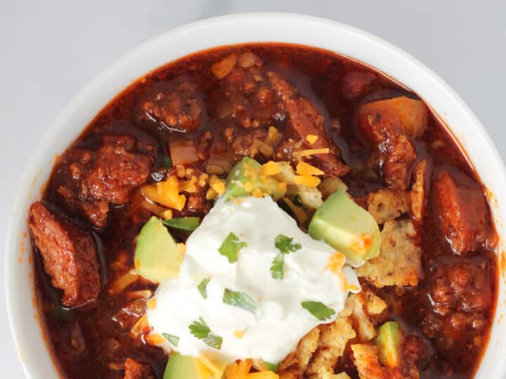 keto chili in a white bowl with garnishes
