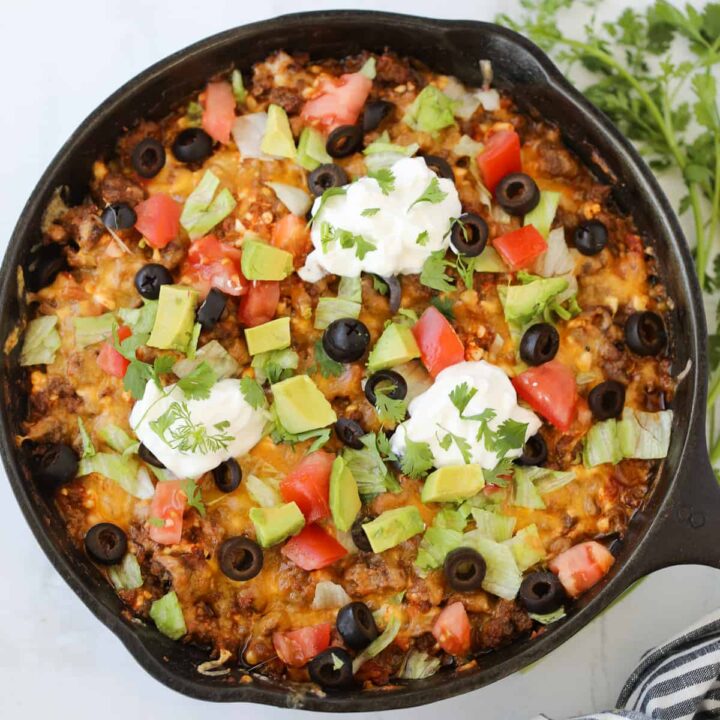 mexican keto casserole with sour cream and other garnishes on top