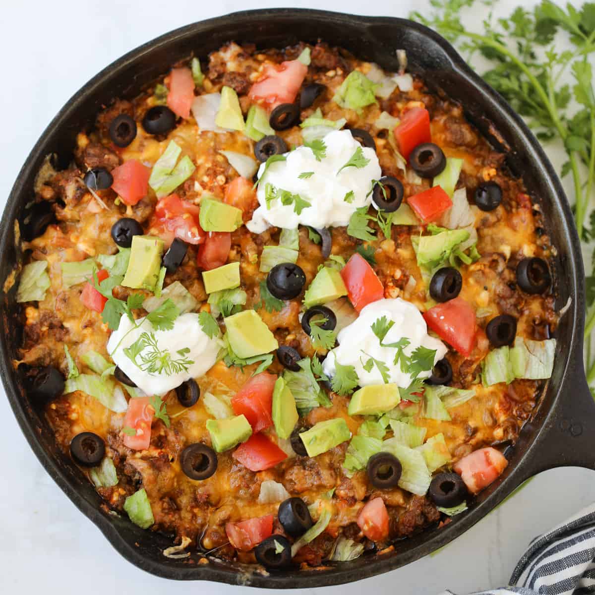 mexican taco casserole with garnishes in the pan
