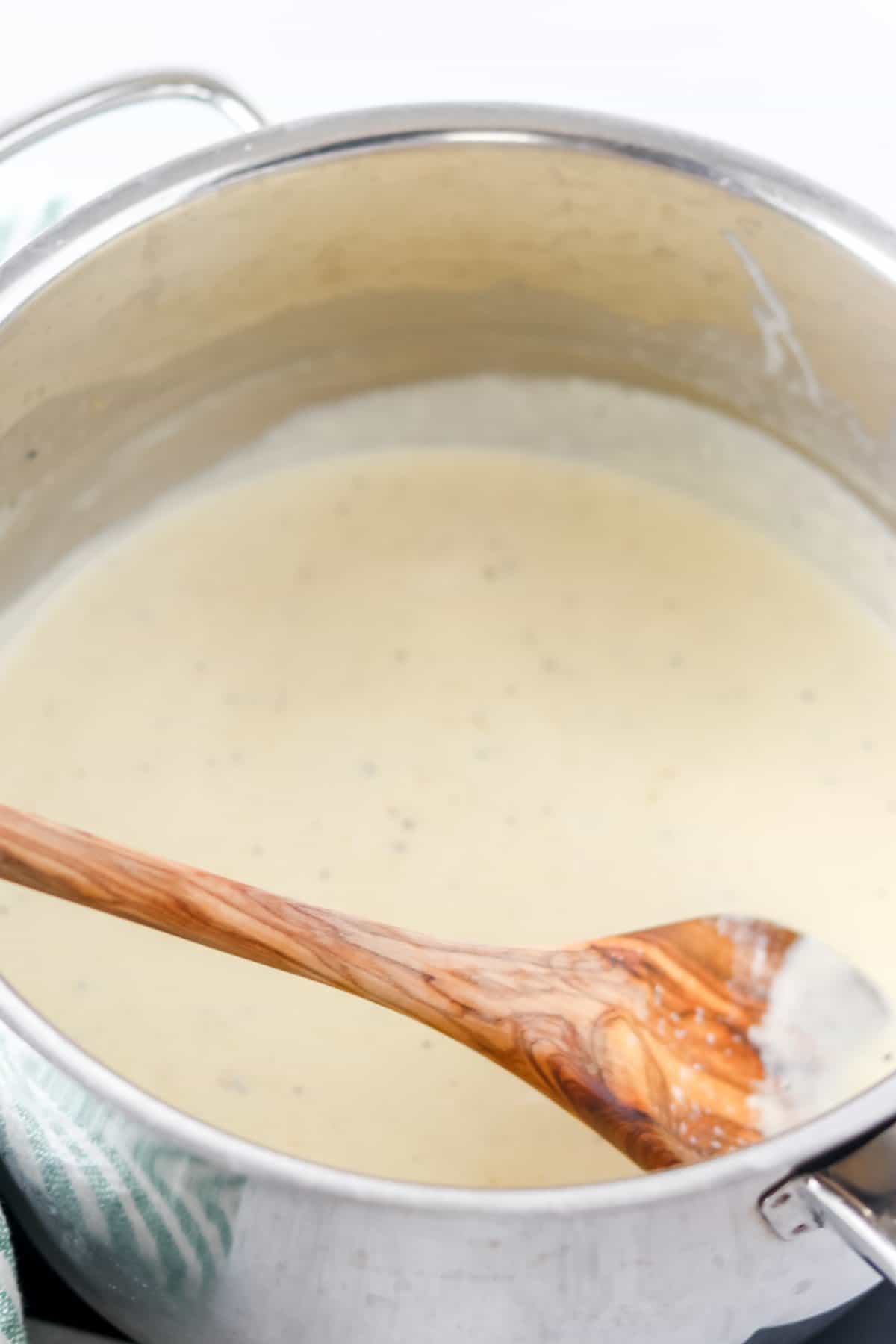 easy alfredo sauce in a skillet after cooking getting stirred