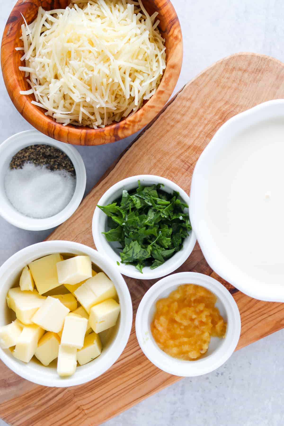 simple alfredo sauce ingredients on a cutting board