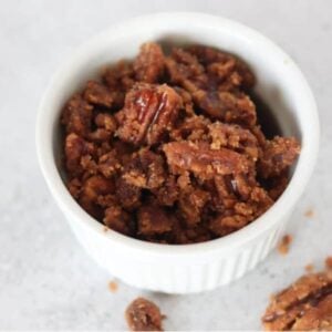 keto candied pecans in a white ramekin after cooking