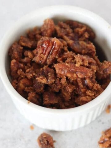 keto candied pecans in a white ramekin after cooking