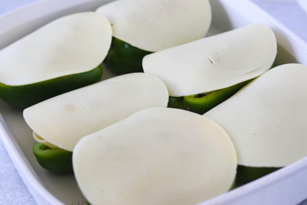 lay a slice of provalone cheese over the top of the Philly cheesesteak peppers