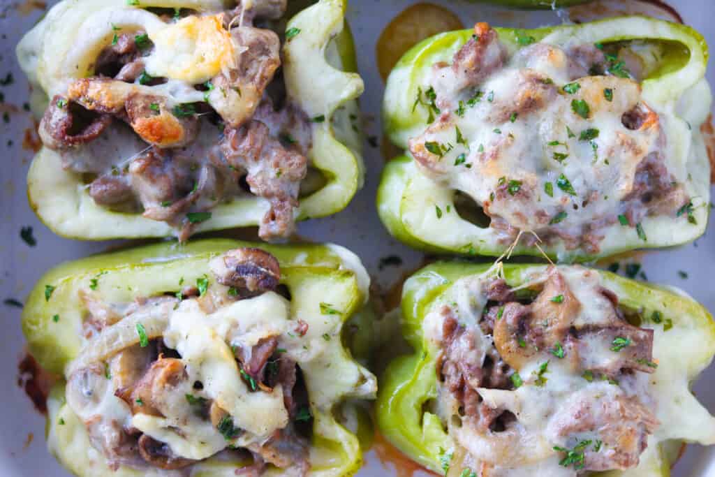 keto Philly cheesesteak stuffed peppers on a baking sheet after cooking with a top down view