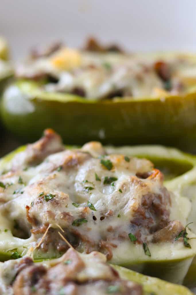 keto cheesesteak stuffed peppers close up photo after getting cooked. Melted cheese and parsley on top