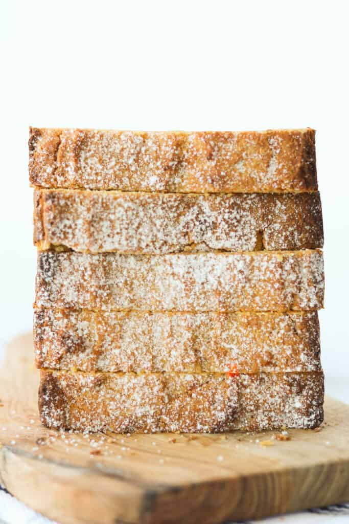 low carb pumpkin bread with cream cheese stacked on a plate