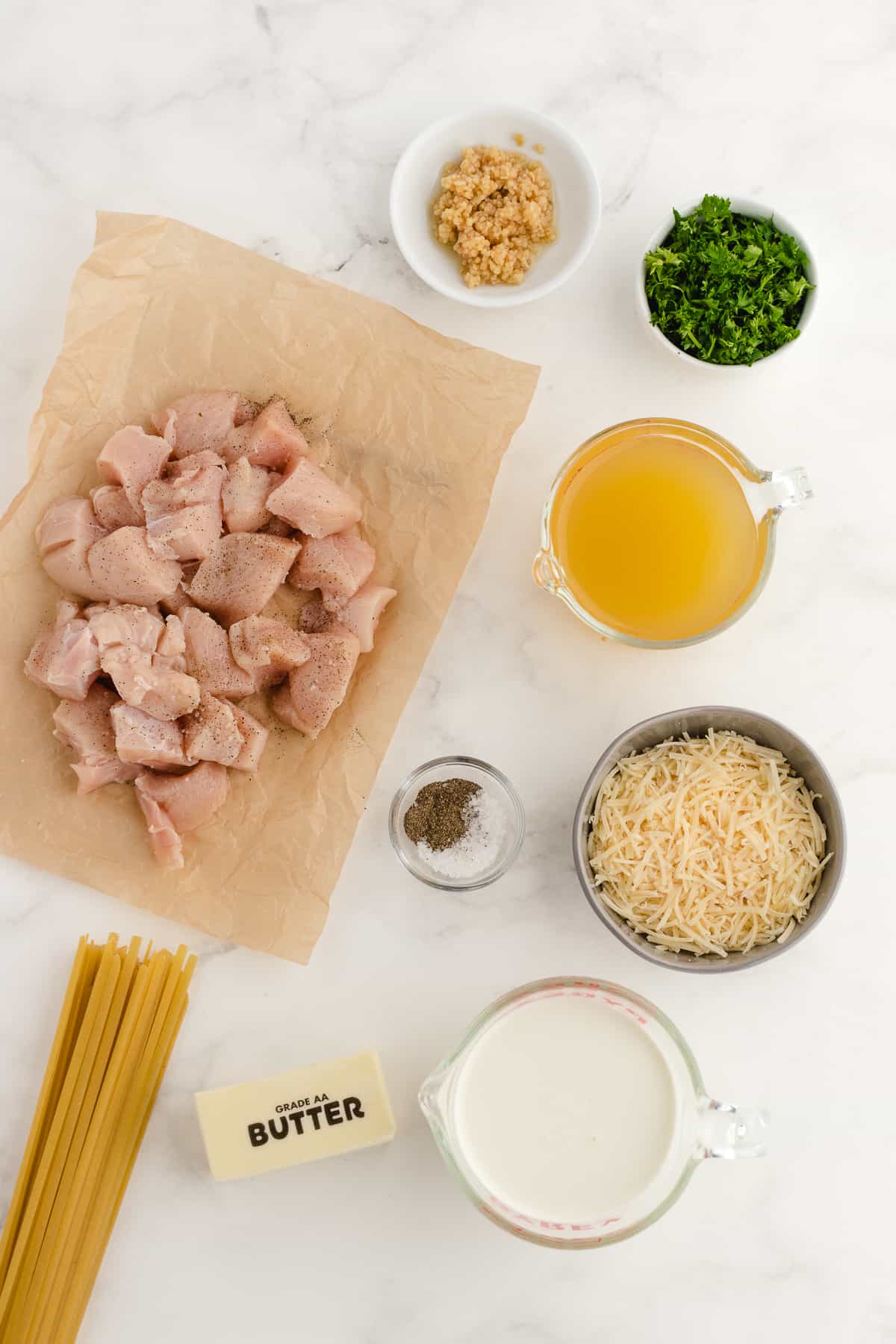 pressure cooker chicken alfredo ingredients on a white board
