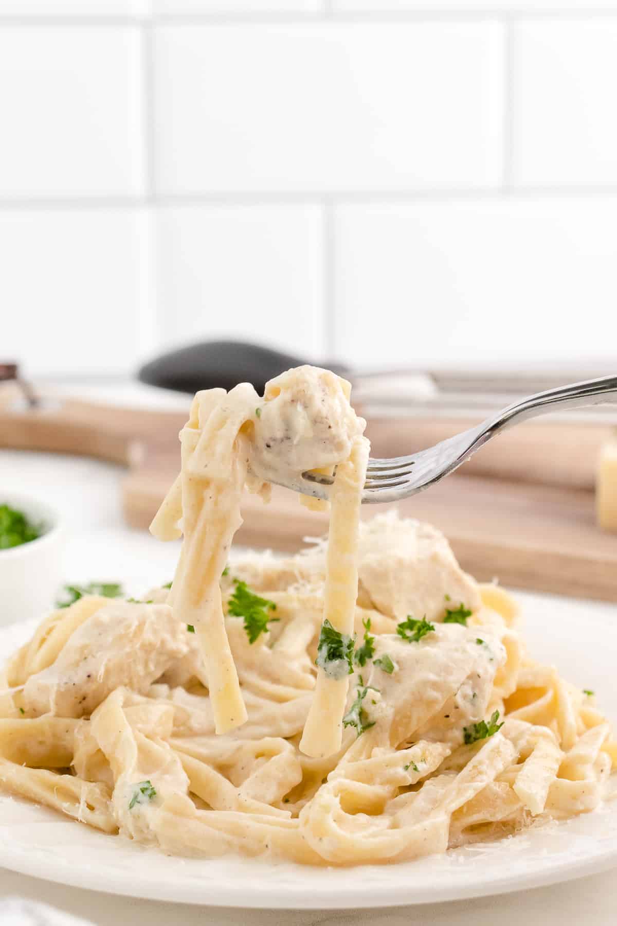 fettuccine alfredo instant pot recipe with a bite of pasta on a fork