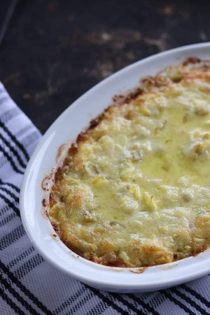 a warm green chili dip on a baking pan fresh out of the oven