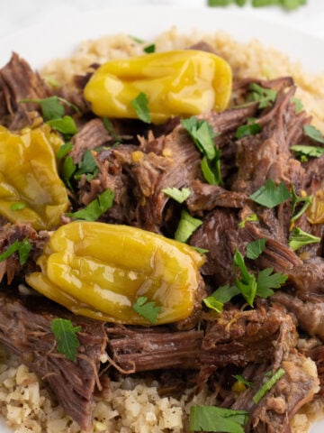 close up of shredded beef on a place with rice