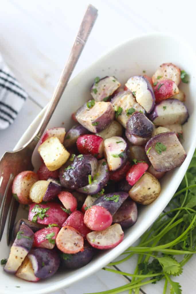 cooked radishes in a white serving bowl