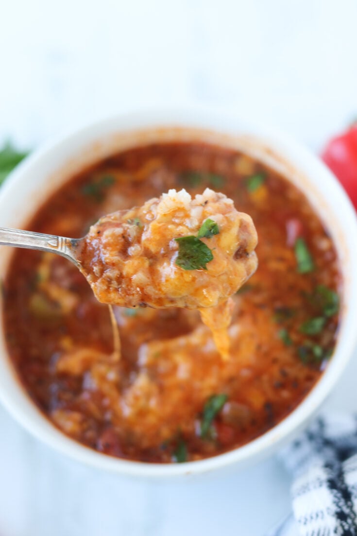 stuffed pepper soup crockpot recipe with a bite on a spoon
