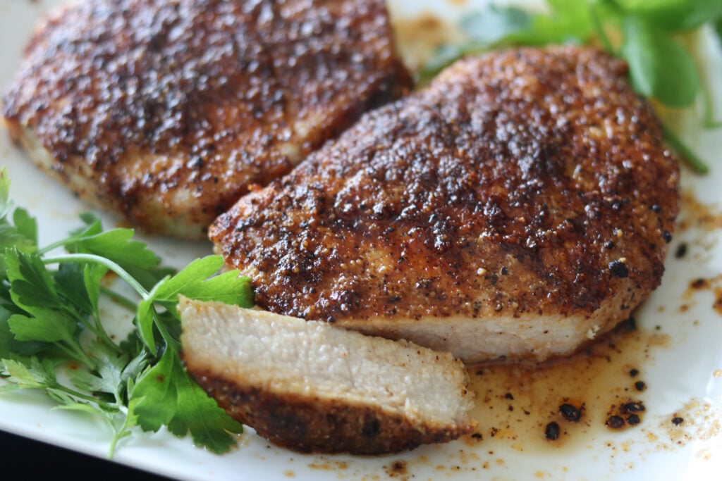 air fryer pork chops no breading ready to be eaten on a plate