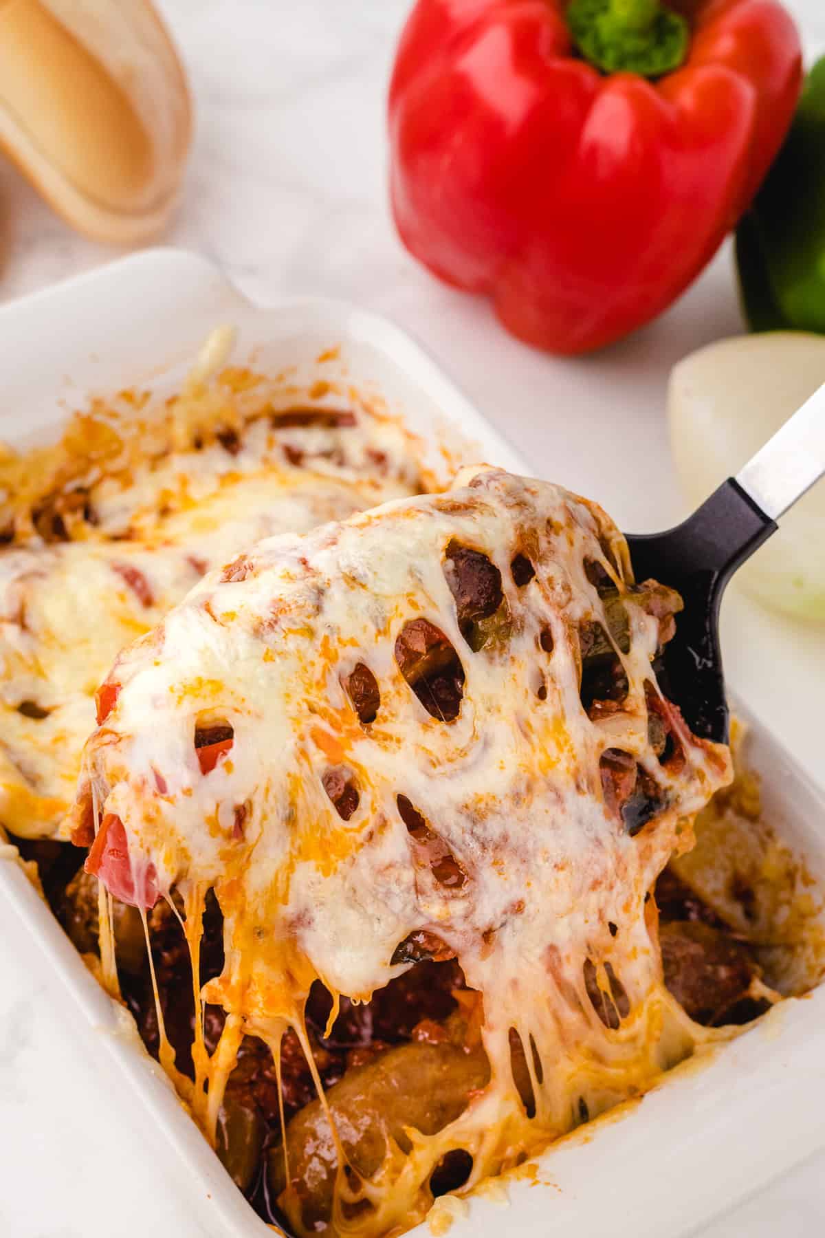 cheesy sausage on a spatula being taken out of the pan