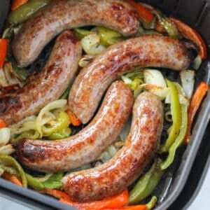air fryer brats in an air fryer basket