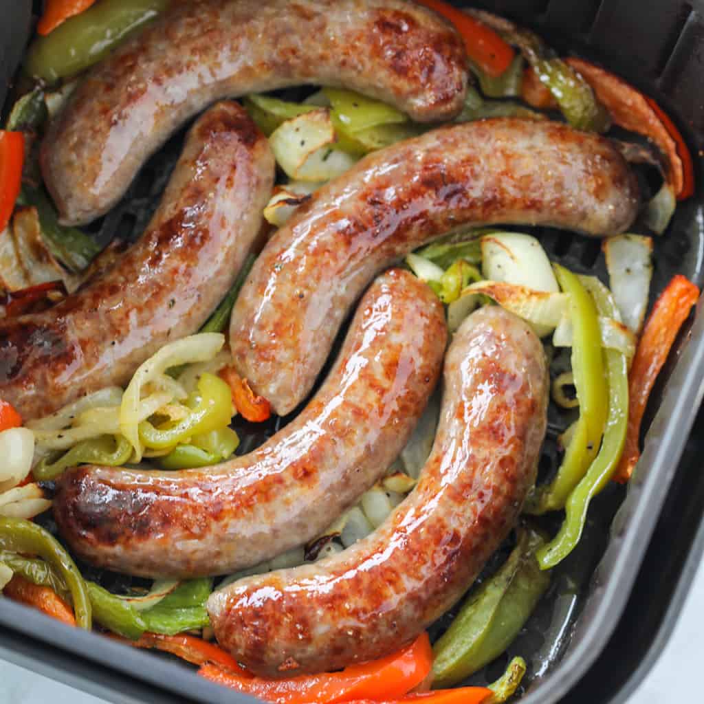 air fryer brats in an air fryer basket