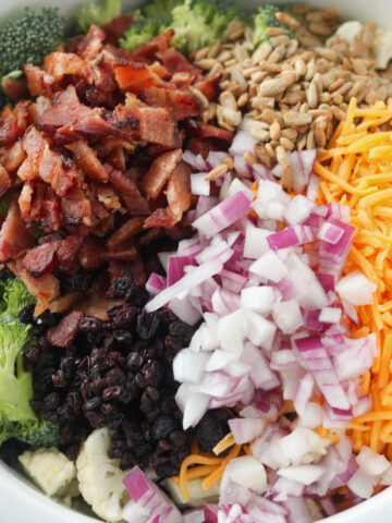 close up of cauliflower broccoli salad with bacon and raisins