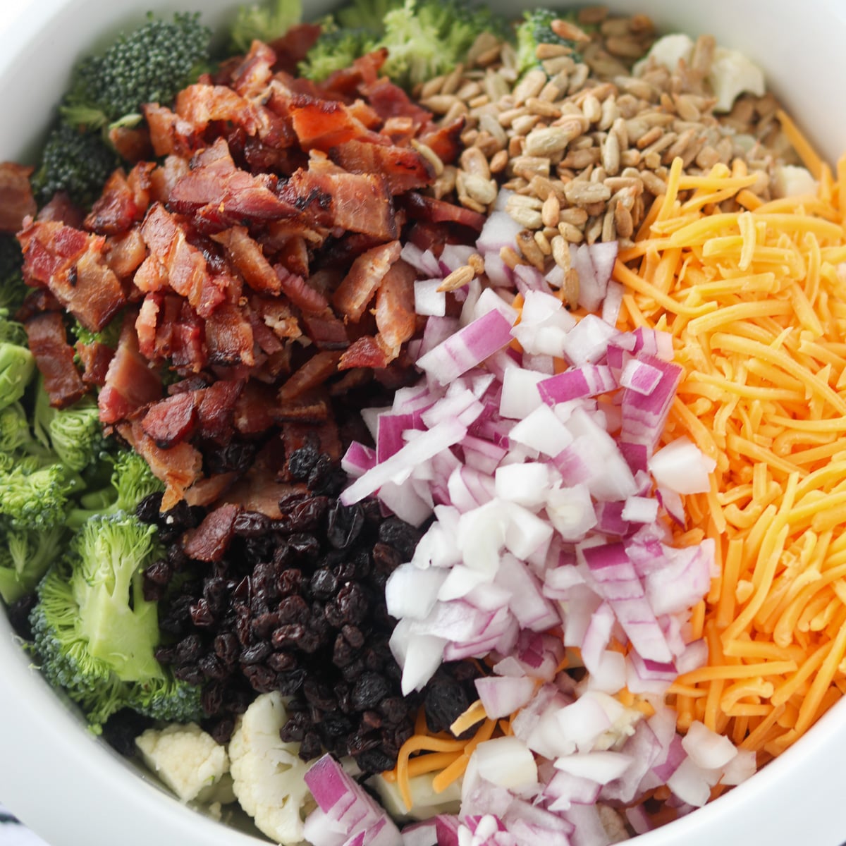 close up of cauliflower broccoli salad with bacon and raisins