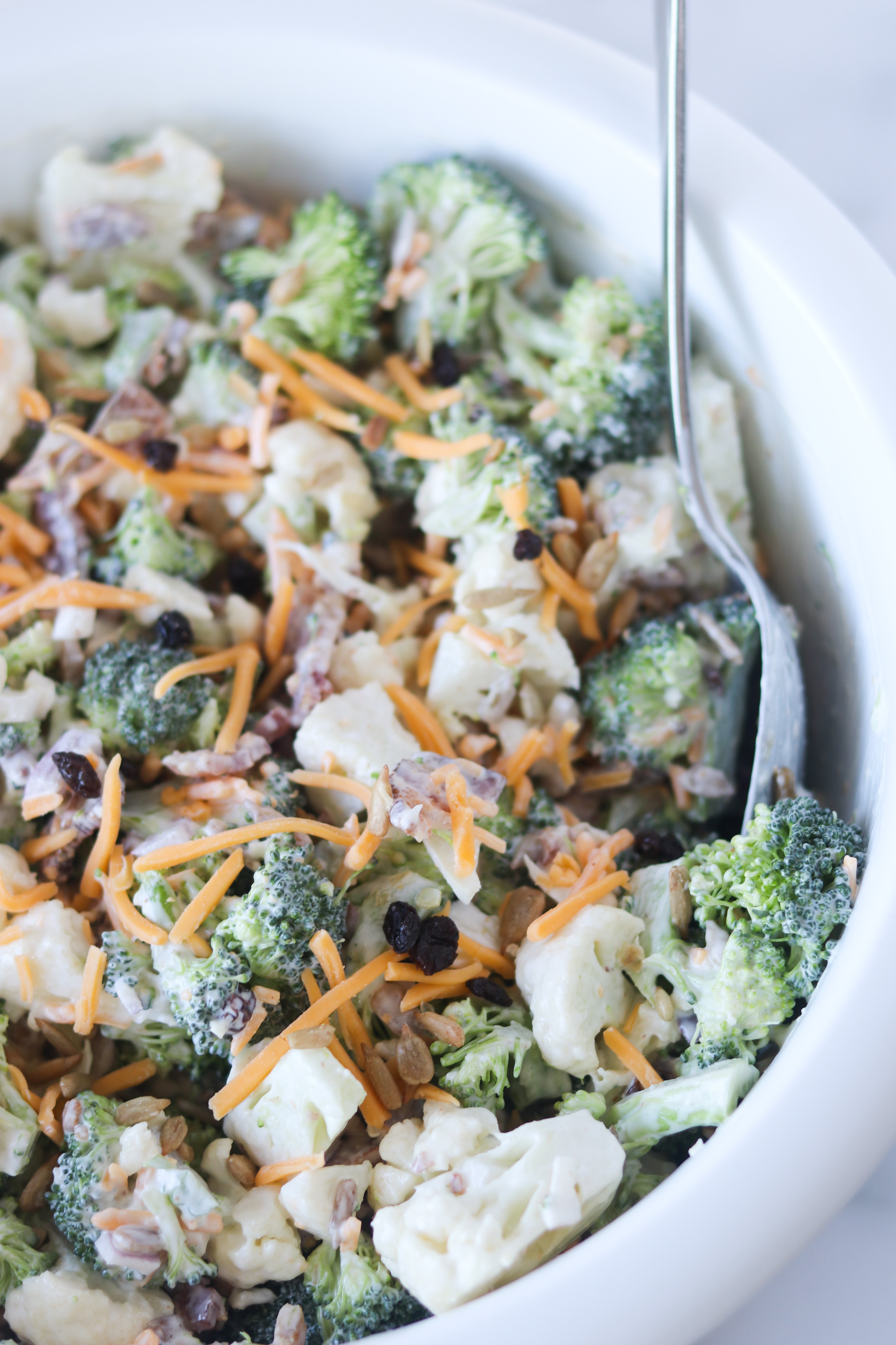 broccoli cauliflower raisin salad tossed with dressing