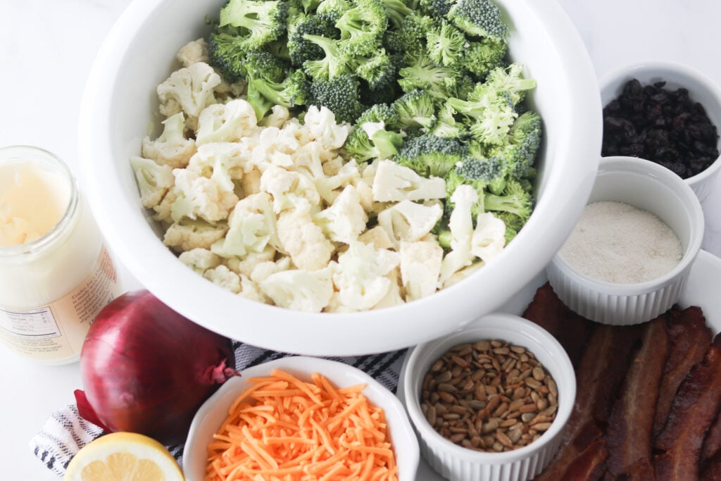 cauliflower broccoli salad recipe ingredients on a cutting board