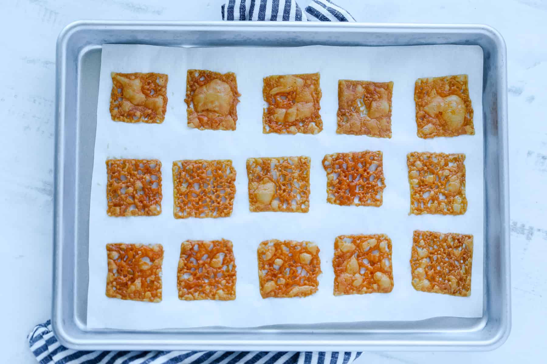 baked cheese slices getting removed from the oven