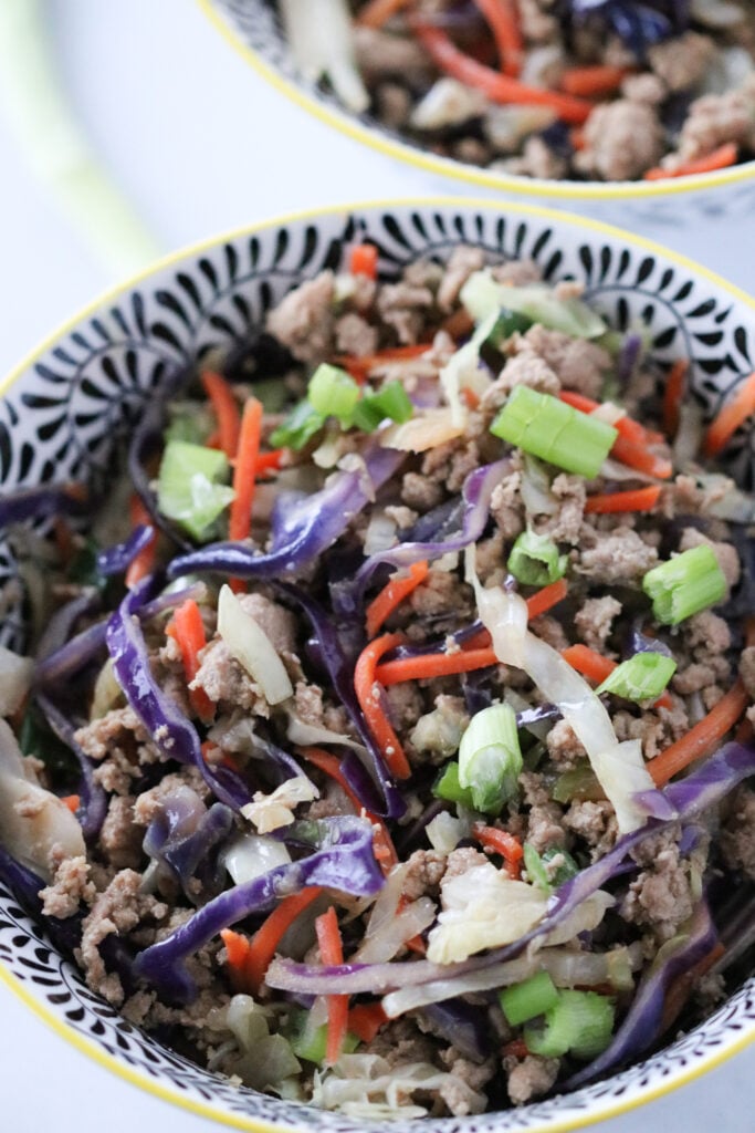 keto crack slaw recipe in an asian bowl on a white background