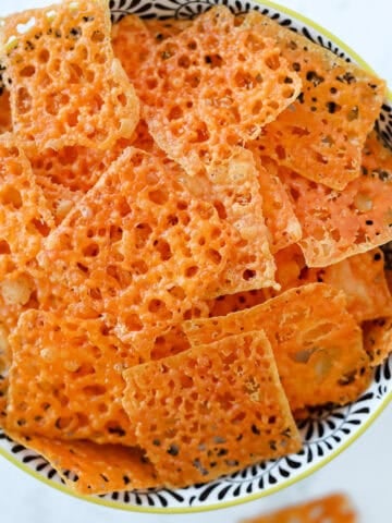 homemade cheese crackers piled up in a bowl after baking