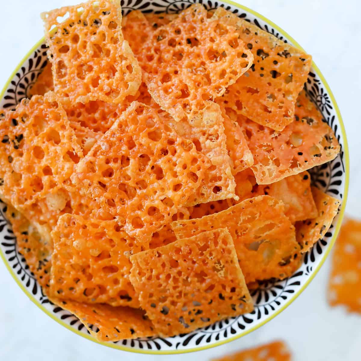 homemade cheese crackers piled up in a bowl after baking