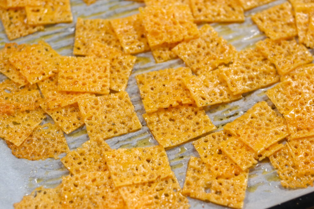 keto cheese crackers cooling on the pan after baking.