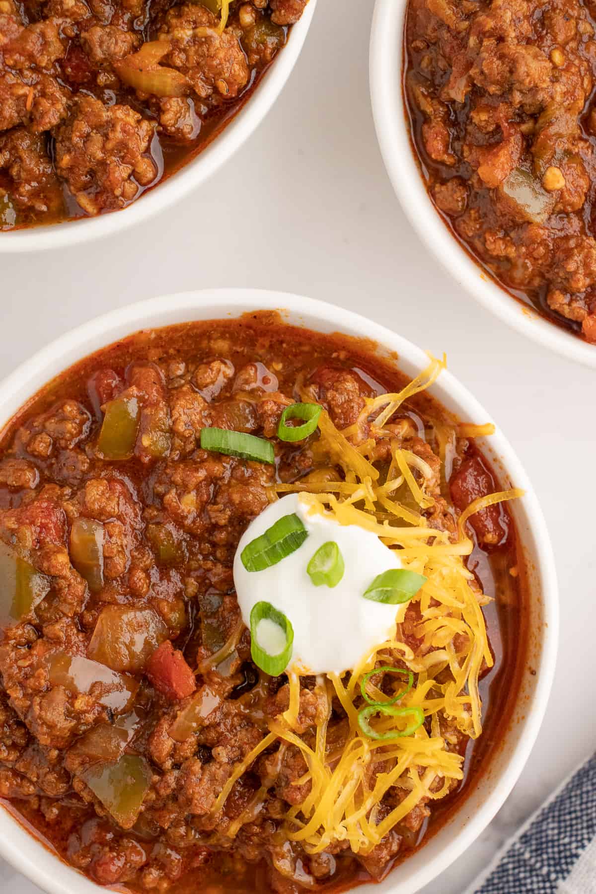 low carb chili recipe with cheese in white bowls