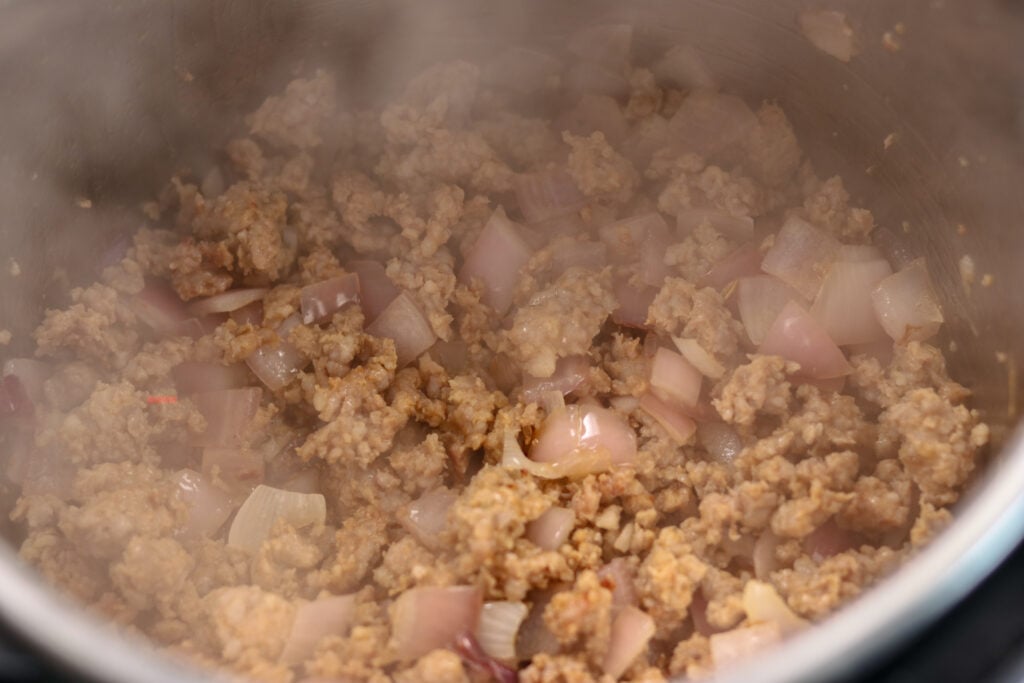the zuppa toscana in instant pot recipe has both sausage and bacon getting cooked