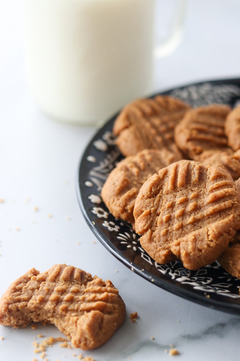 3 ingredient peanut butter cookies on a plate with milk