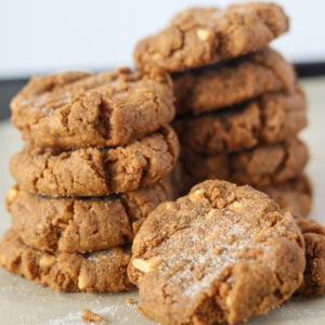 3 ingredient peanut butter cookies stacked up on parchment paper