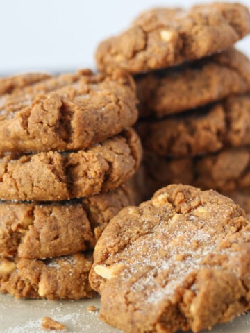 3 ingredient peanut butter cookies stacked up on parchment paper