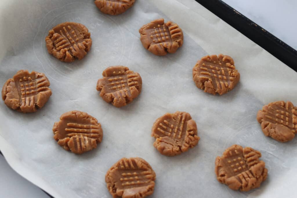 press the 3 ingredient peanut butter cookies with a fork to flatten
