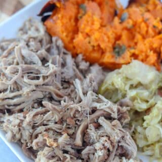 hawaiian pork on a plate with cabbage and sweet potatoes